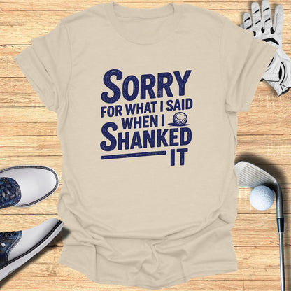 T-shirt with "Sorry for what I said when I shanked it" text and golf accessories.