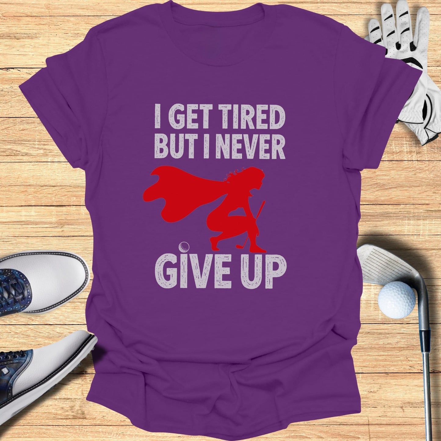 Purple t-shirt with "I GET TIRED BUT I NEVER GIVE UP" graphic.