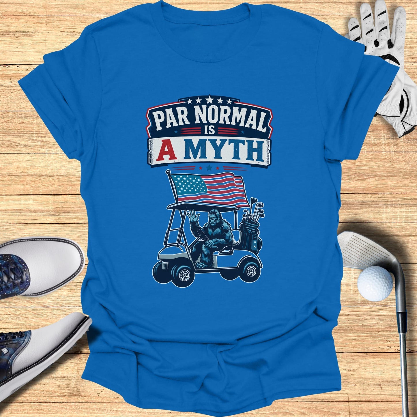 Blue t-shirt with "Par Normal is a Myth" text, gorilla in golf cart with American flag.