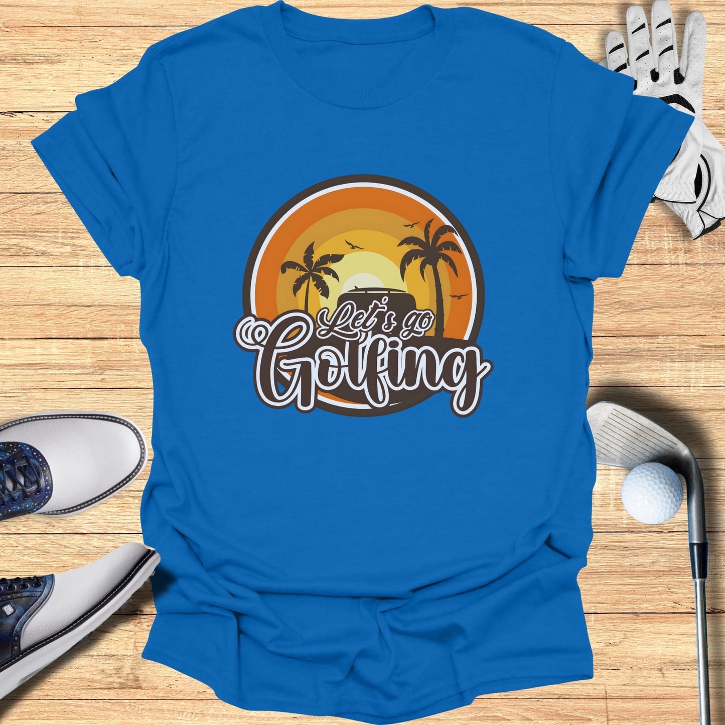 Blue t-shirt with "Let's Go Golfing" text and a sunset golf scene graphic.