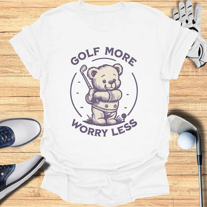 White t-shirt with purple text and graphics of a teddy bear playing golf.