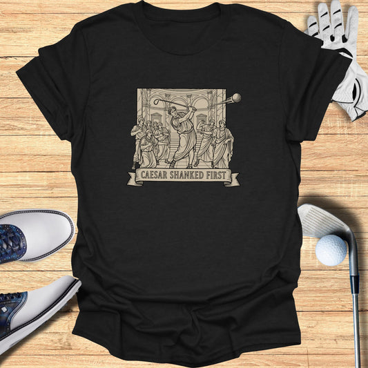 Black t-shirt with Roman-style illustration of Caesar golfing.