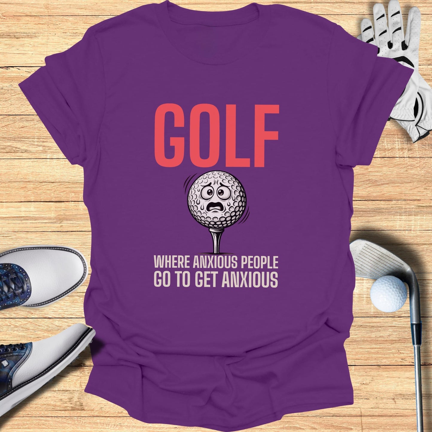 Purple t-shirt with "GOLF WHERE ANXIOUS PEOPLE GO TO GET ANXIOUS" and a worried golf ball.