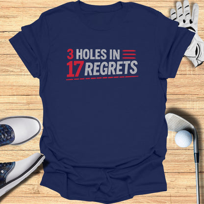 Navy t-shirt with "3 HOLES IN 17 REGRETS" text and golf accessories.
