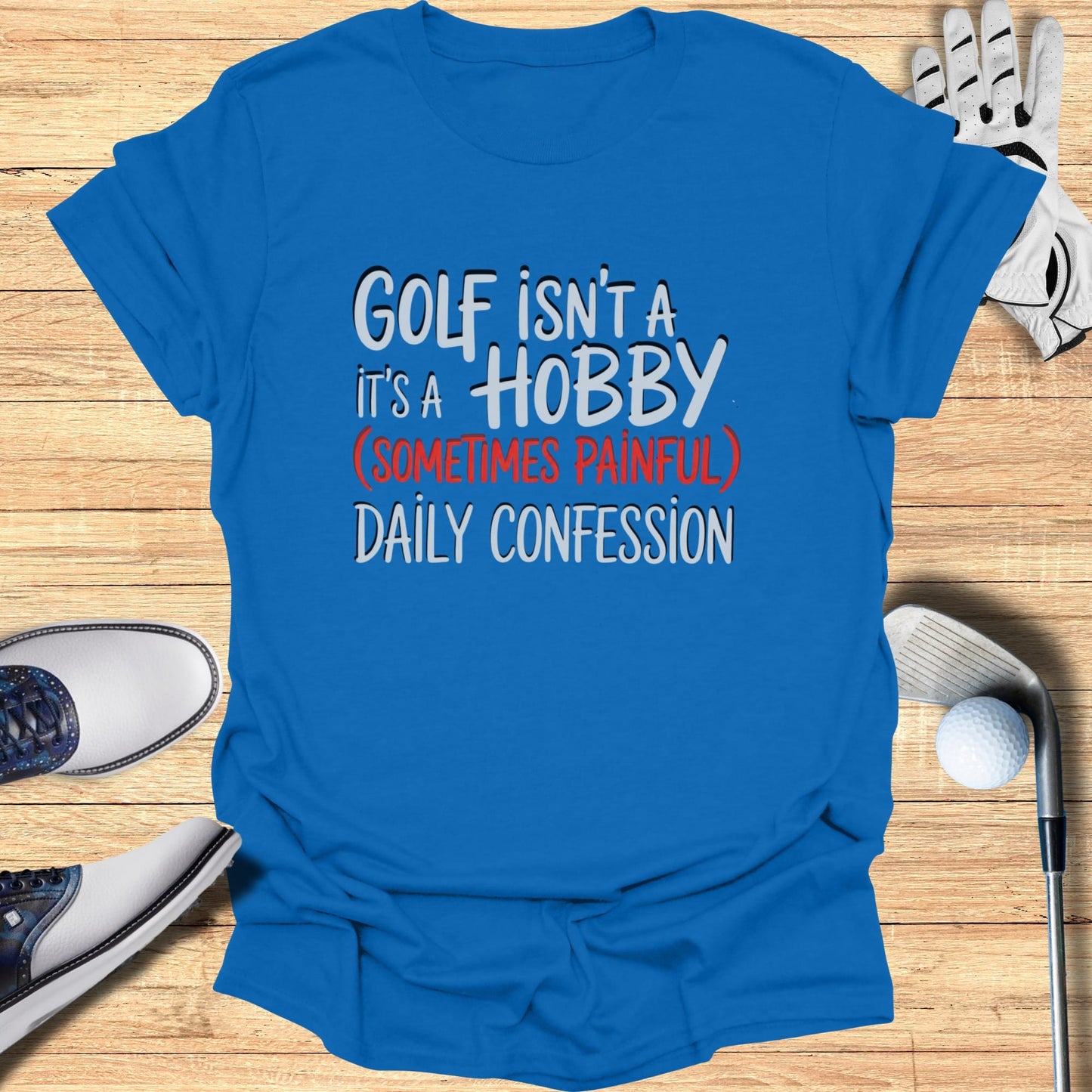 Blue t-shirt with white text "GOLF ISN'T A HOBBY (SOMETIMES PAINFUL) DAILY CONFESSION".