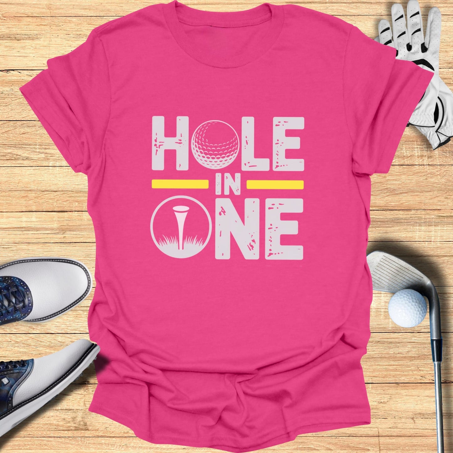 Pink t-shirt with "HOLE IN ONE" text and golf ball graphic.