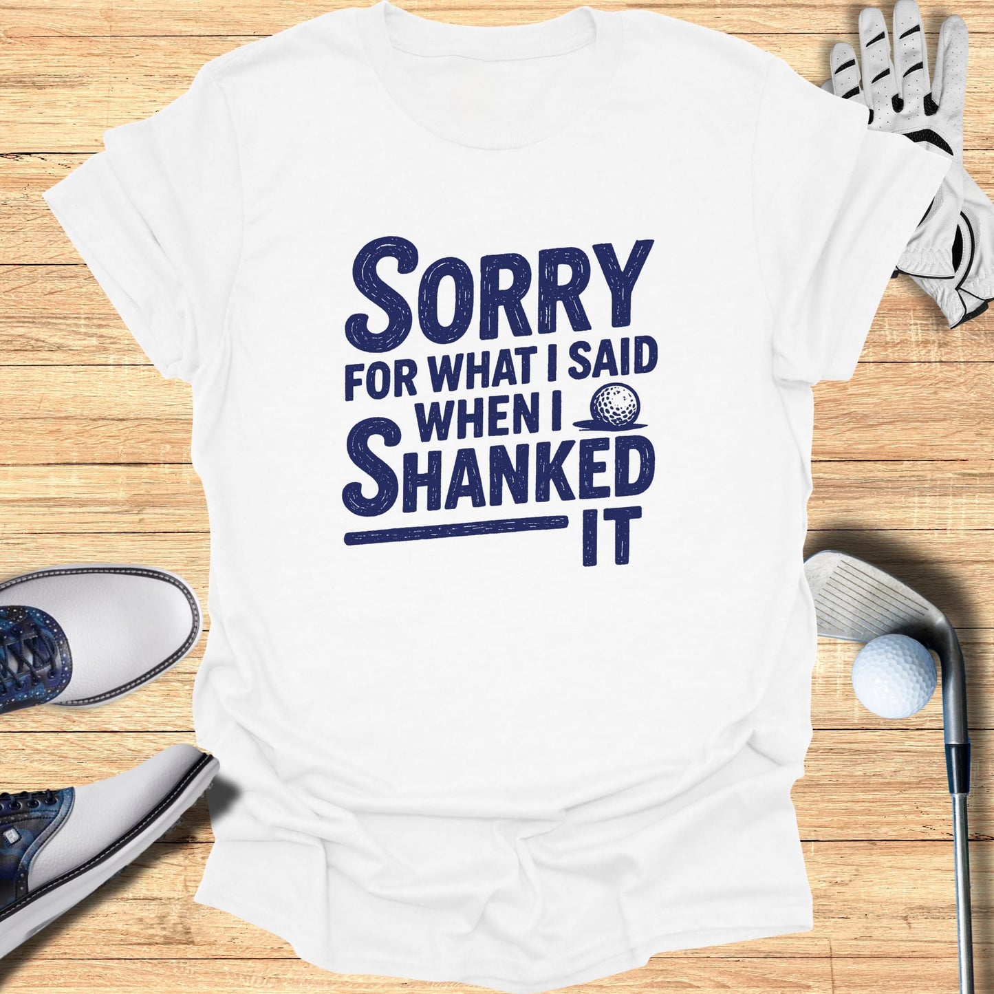 White t-shirt with navy blue text: "Sorry for what I said when I shanked it."