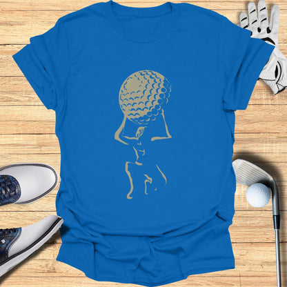 Gold golfer silhouette holding a large golf ball on blue t-shirt.