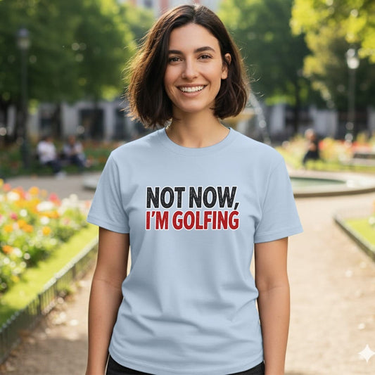 Light blue t-shirt with "NOT NOW, I'M GOLFING" text.