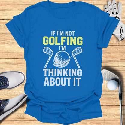Blue t-shirt with "If I'm not golfing, I'm thinking about it" text and golf club graphic.