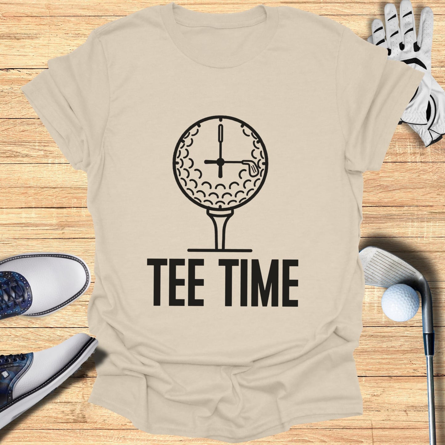 Tee Time text with a golf ball clock on a beige t-shirt.