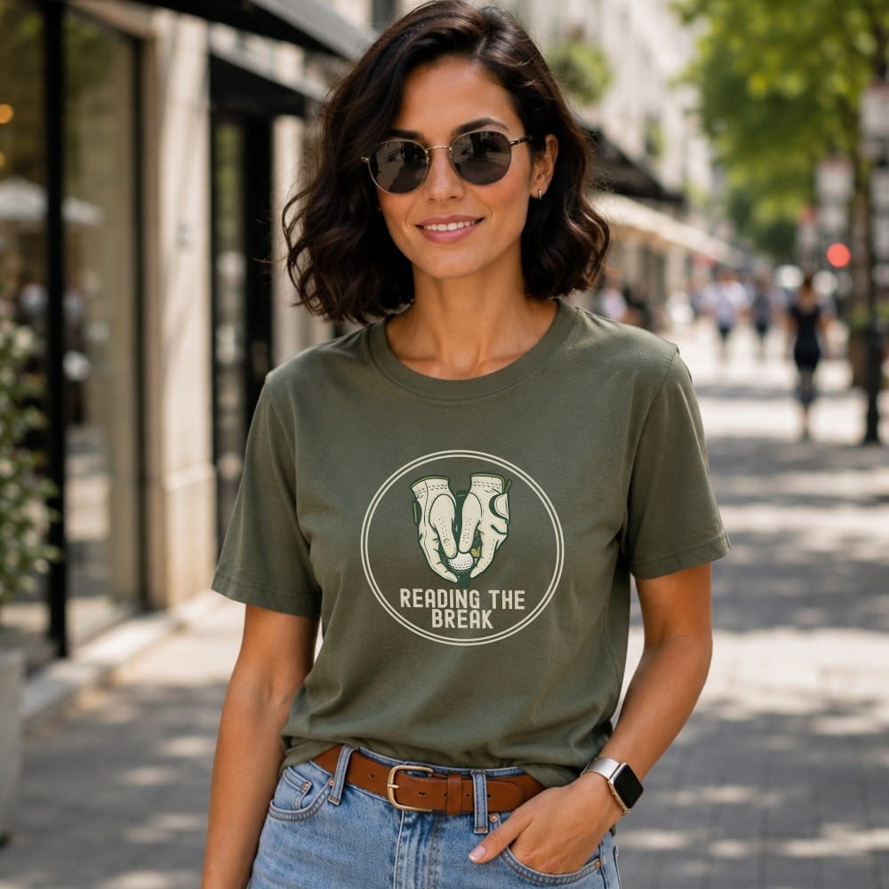 Woman wearing a green t-shirt with a book and coffee cup graphic.
