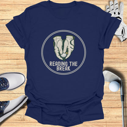 Navy t-shirt with "Reading the Break" golf graphic on wooden background.