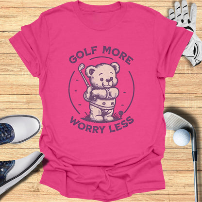 Pink t-shirt with a cartoon bear golfing and the text "Golf More Worry Less."