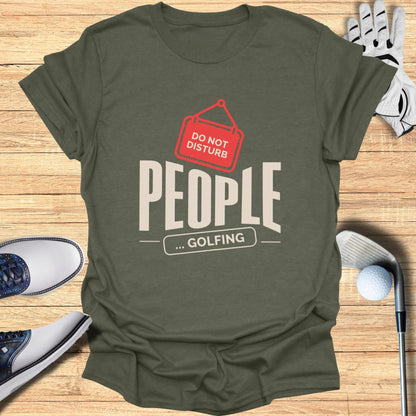 Olive green t-shirt with "DO NOT DISTURB ... GOLFING" graphic.