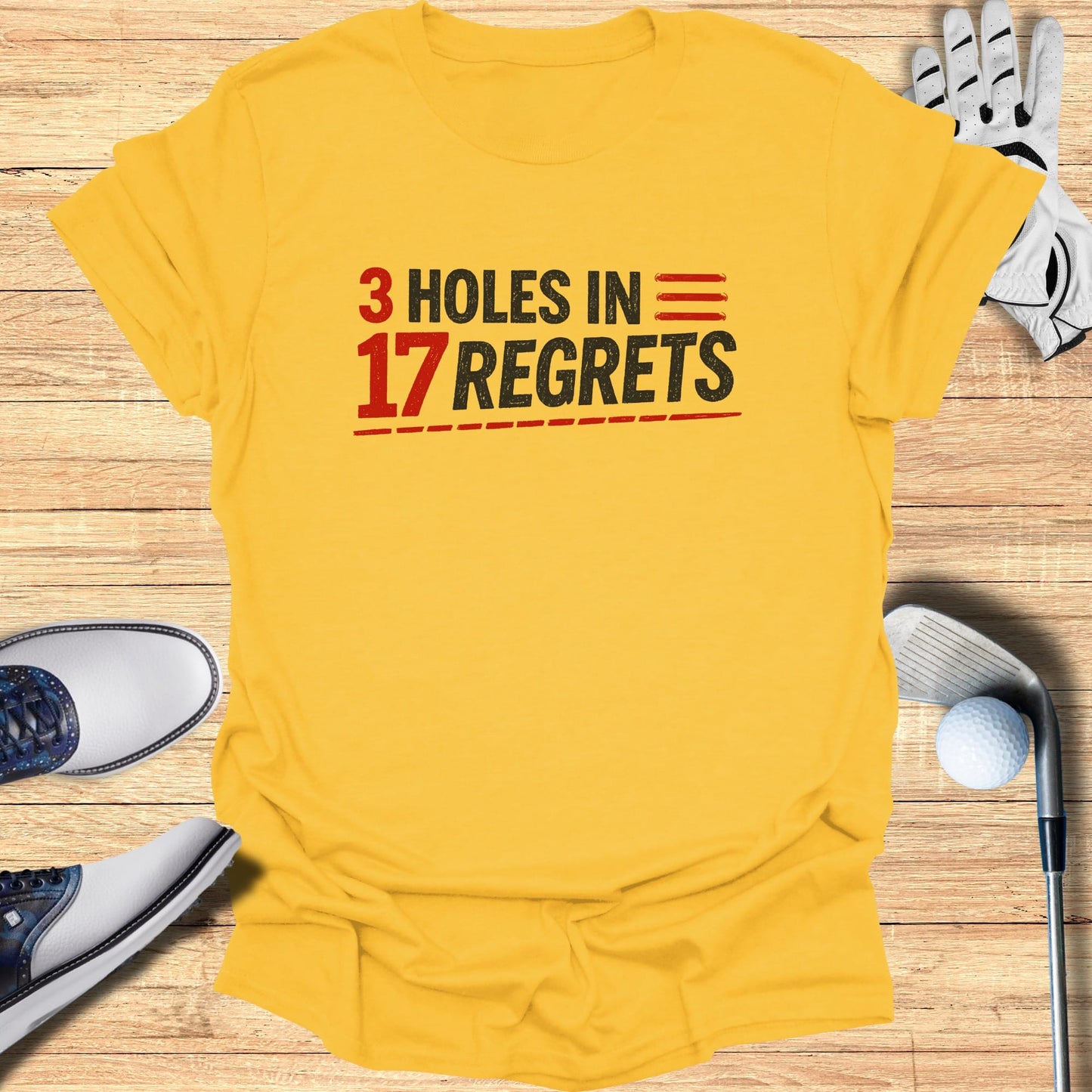 Yellow t-shirt with "3 HOLES IN 17 REGRETS" text.