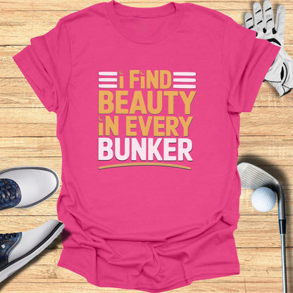 Pink t-shirt with "I FIND BEAUTY IN EVERY BUNKER" text.