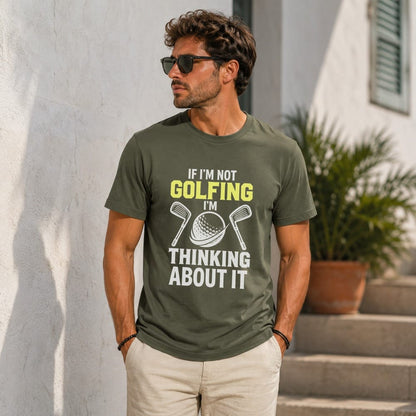 Man wearing a green t-shirt with text "IF I'M NOT GOLFING I'M THINKING ABOUT IT" and golf clubs.