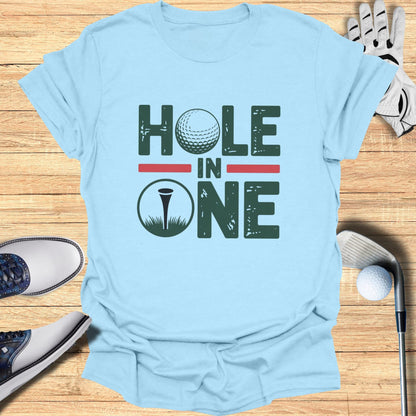 Light blue t-shirt with "Hole In One" text and golf ball graphic.