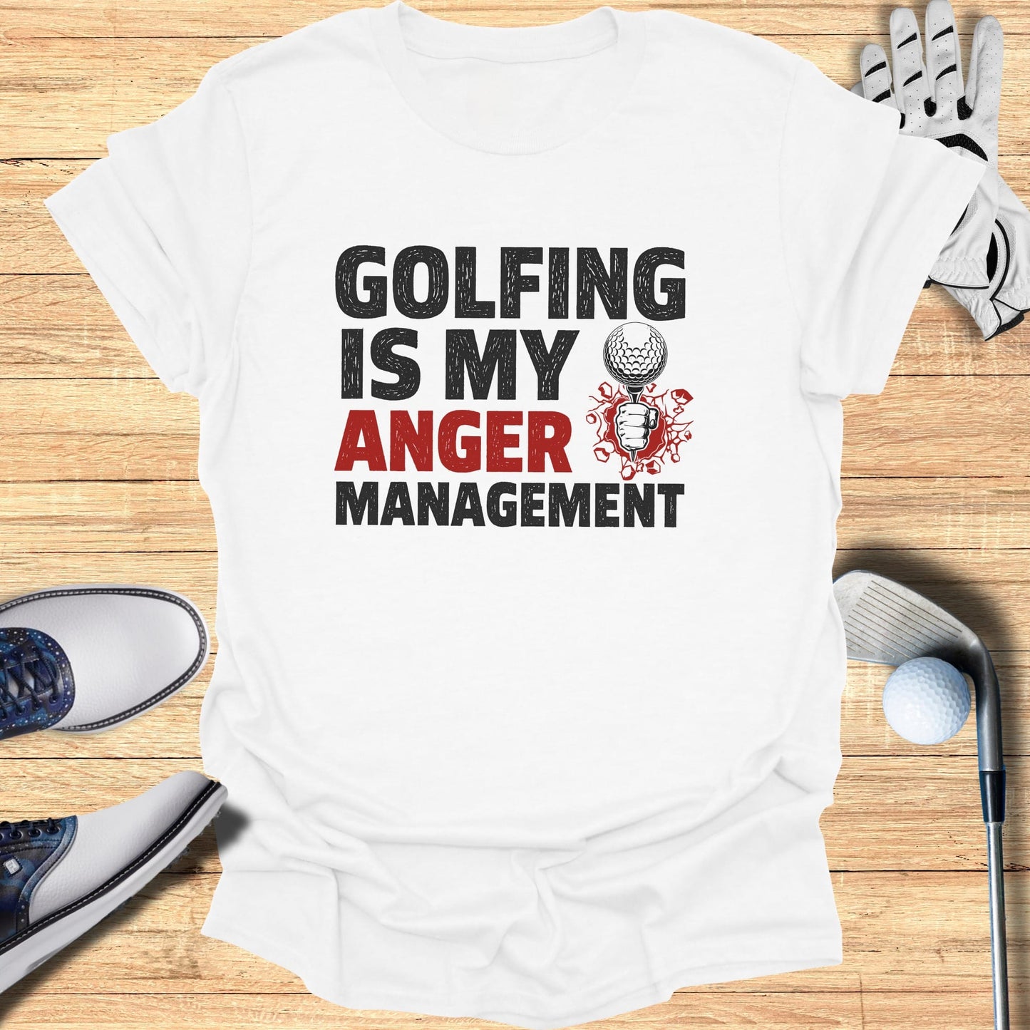 White t-shirt with "Golfing is my anger management" graphic and golf accessories.