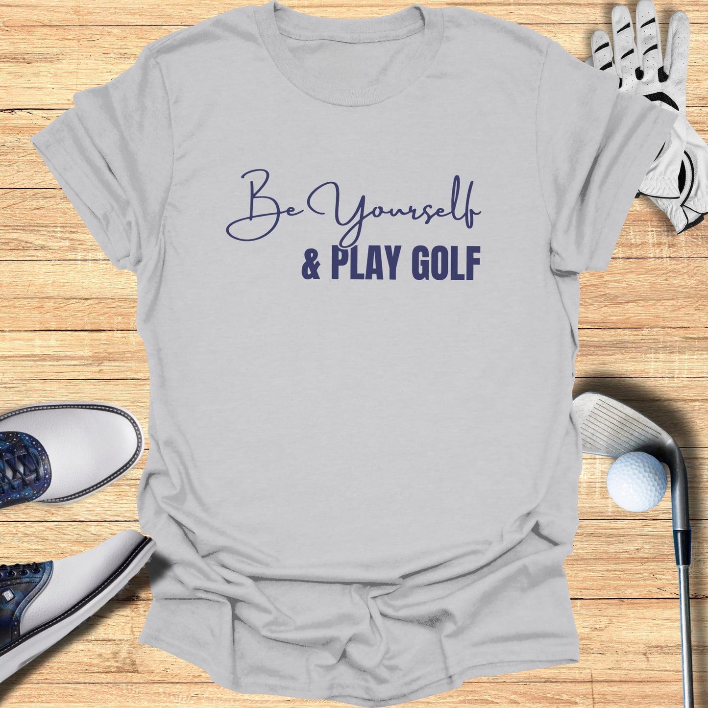 Light grey t-shirt with "Be Yourself & PLAY GOLF" text in blue script.