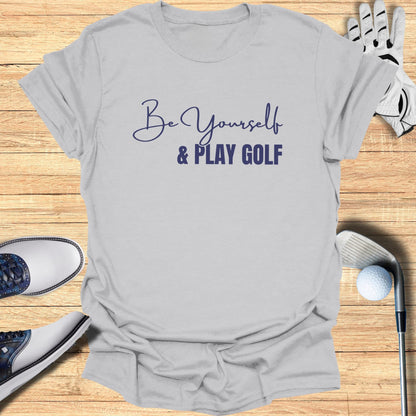 Light grey t-shirt with "Be Yourself & PLAY GOLF" text in blue script.