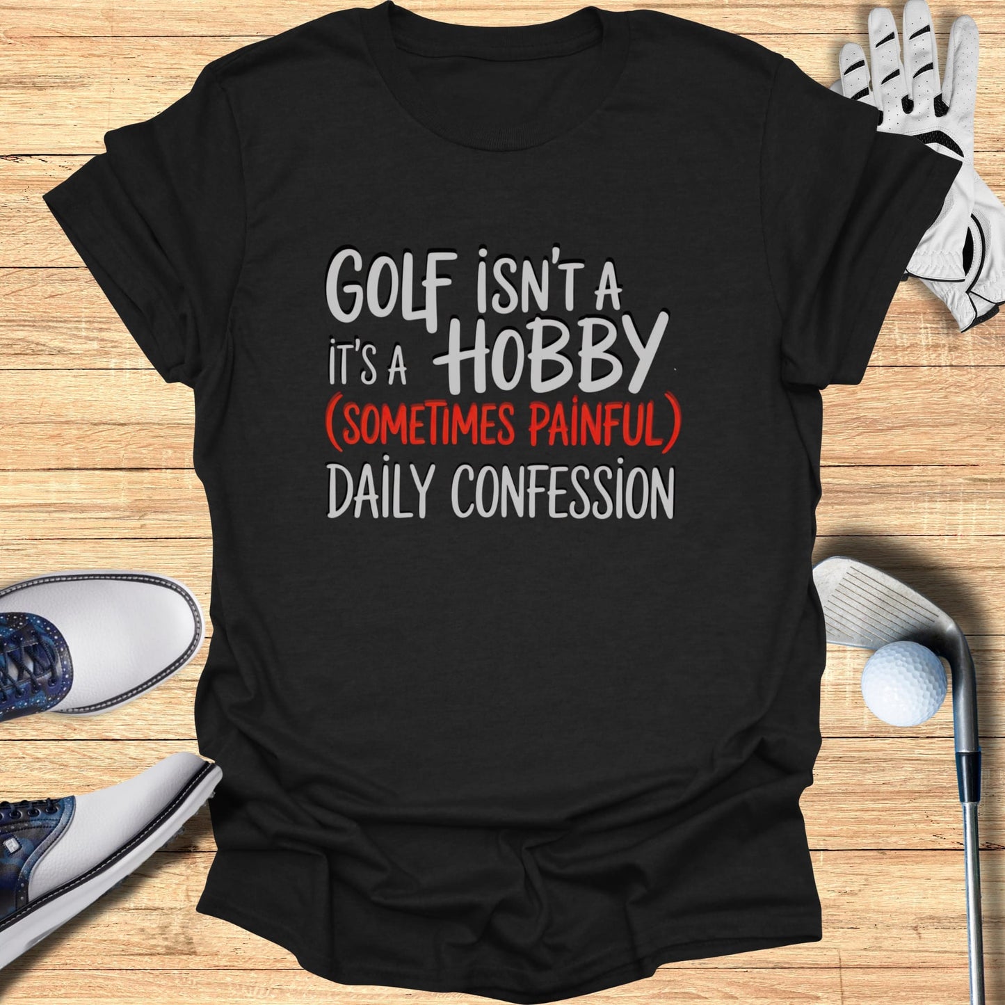 Black t-shirt with text "Golf isn't a hobby it's a (sometimes painful) daily confession".