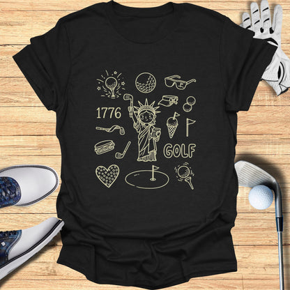 T-shirt with patriotic golf doodles: Statue of Liberty, golf club, ball, and sunglasses.
