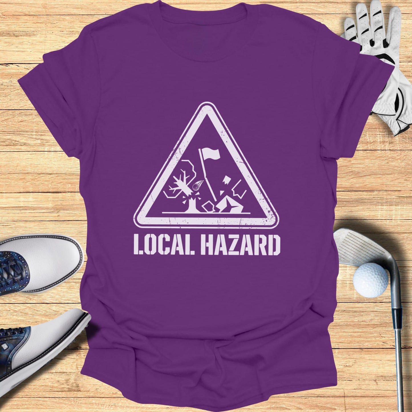 Purple t-shirt with white "Local Hazard" text and golf hazard graphic.