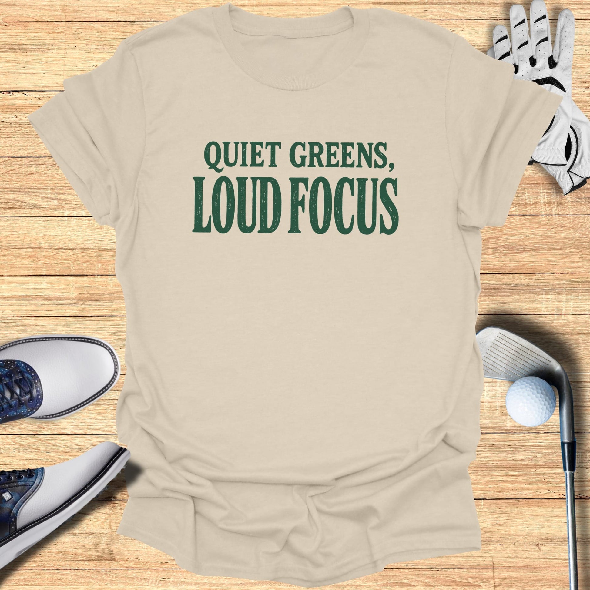 Cream t-shirt with "Quiet Greens, Loud Focus" in green text.