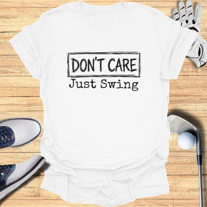 White t-shirt with "DON'T CARE Just Swing" text, next to golf accessories.