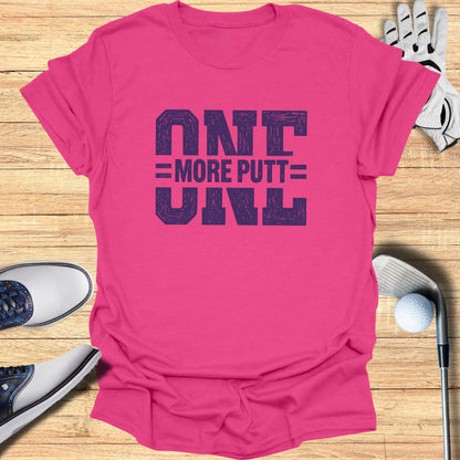 Pink t-shirt with "ONE MORE PUTT" text in bold, block letters.