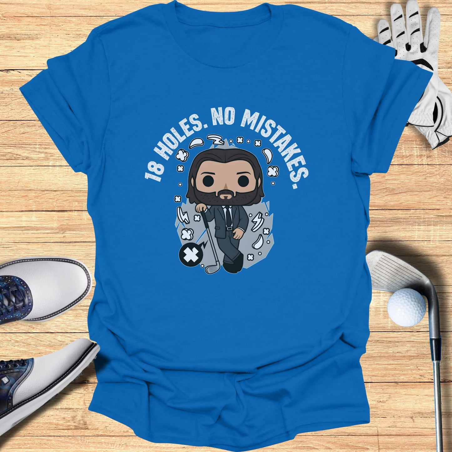 Blue t-shirt with cartoon golfer and "18 HOLES. NO MISTAKES." text.