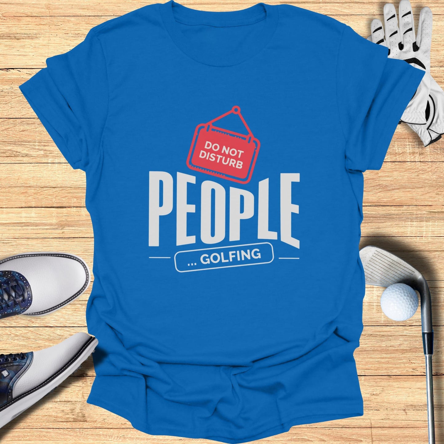 Blue t-shirt with "Do Not Disturb People... Golfing" text and golf accessories.