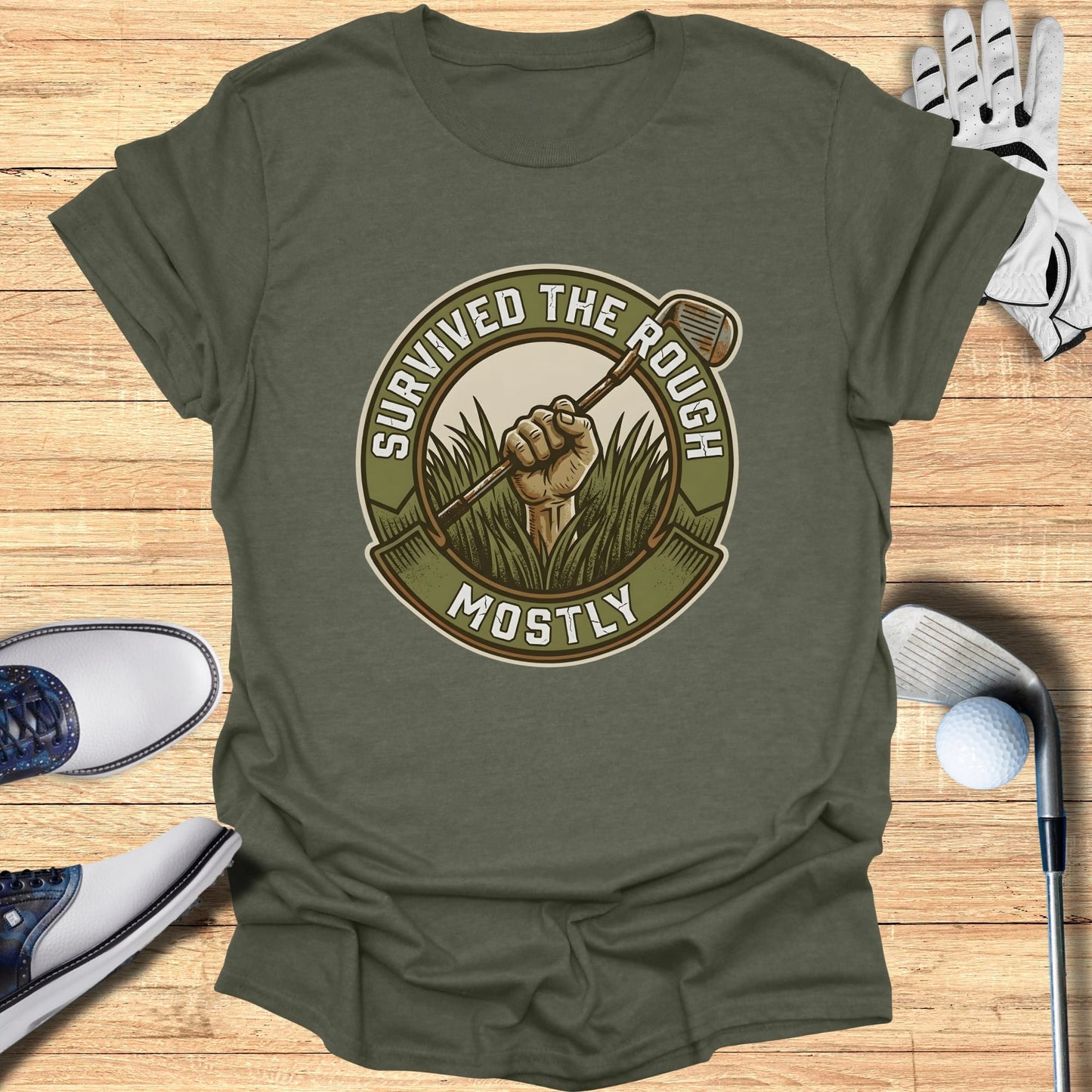 Olive green t-shirt with "Survived the Rough Mostly" text and golf club graphic.