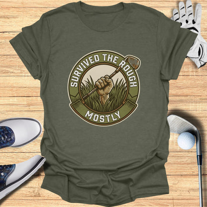 Olive green t-shirt with "Survived the Rough Mostly" text and golf club graphic.