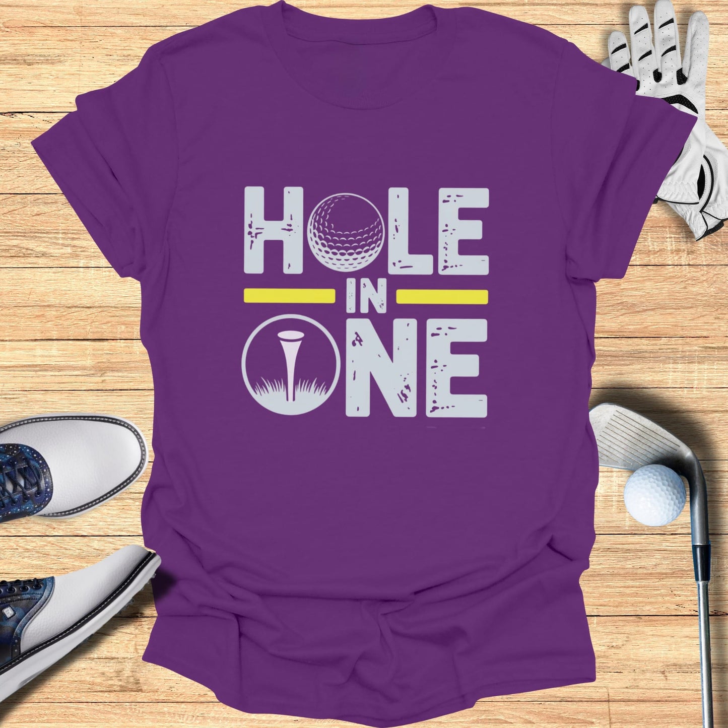 Purple t-shirt with "Hole in One" text and golf ball graphic.