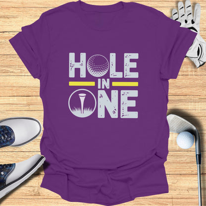 Purple t-shirt with "Hole in One" text and golf ball graphic.