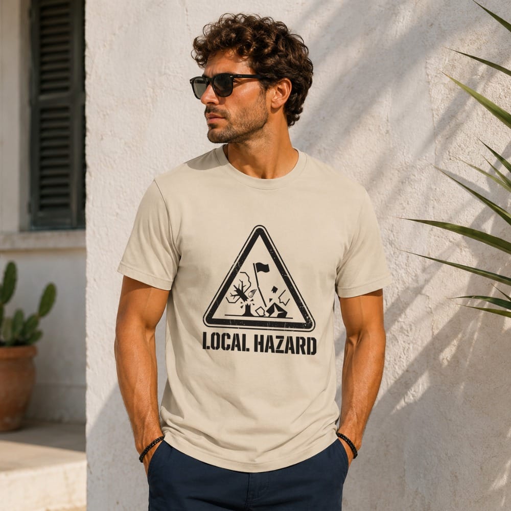Man wearing a beige t-shirt with a black "Local Hazard" triangle graphic.