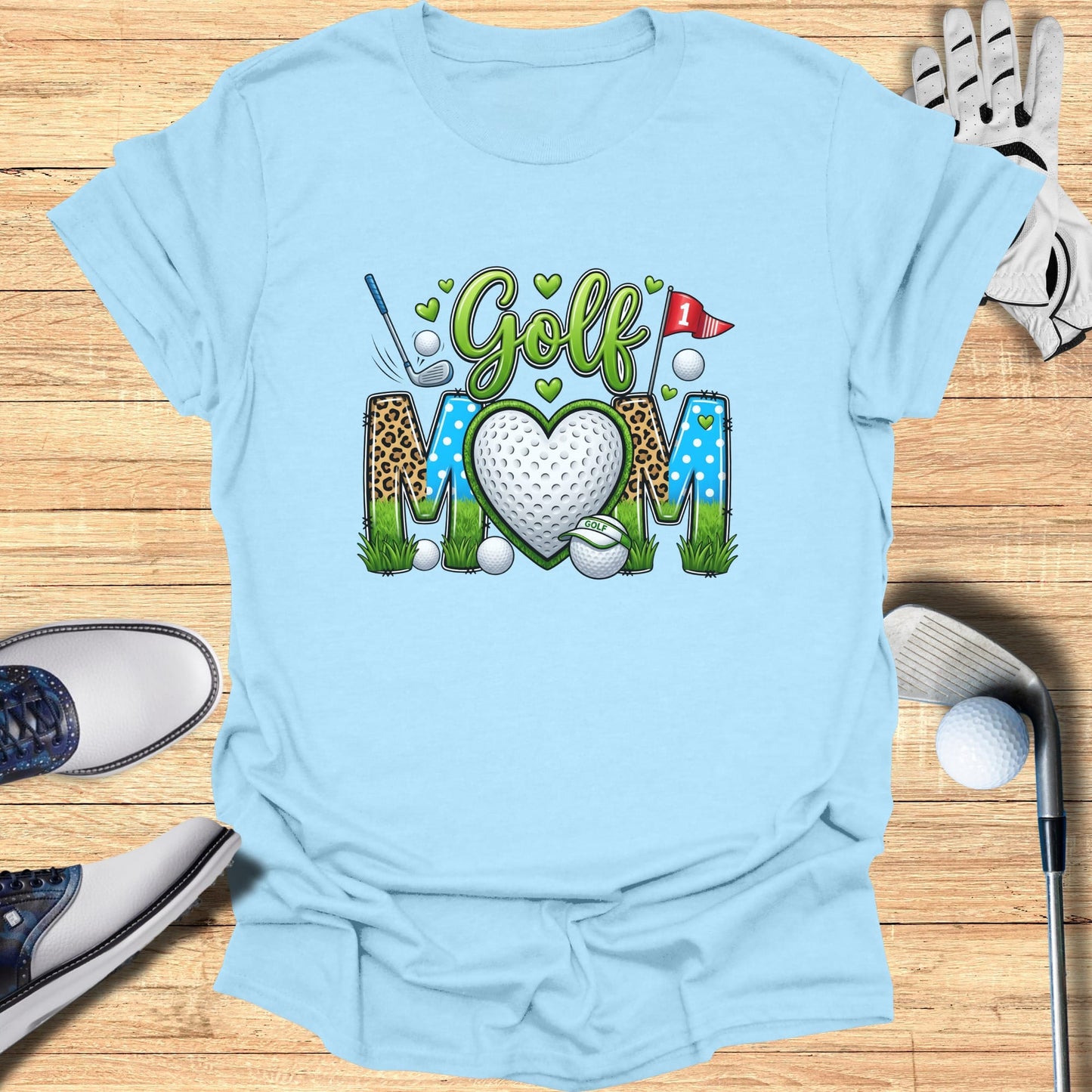 Light blue t-shirt with "Golf Mom" text and a heart-shaped golf ball graphic.
