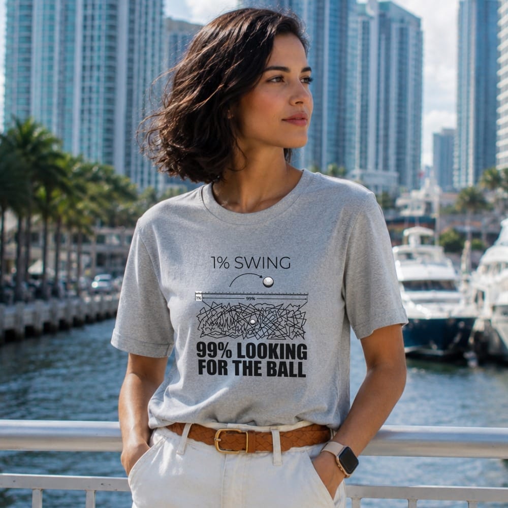 Grey t-shirt with "1% SWING 99% LOOKING FOR THE BALL" text and golf ball graphic.