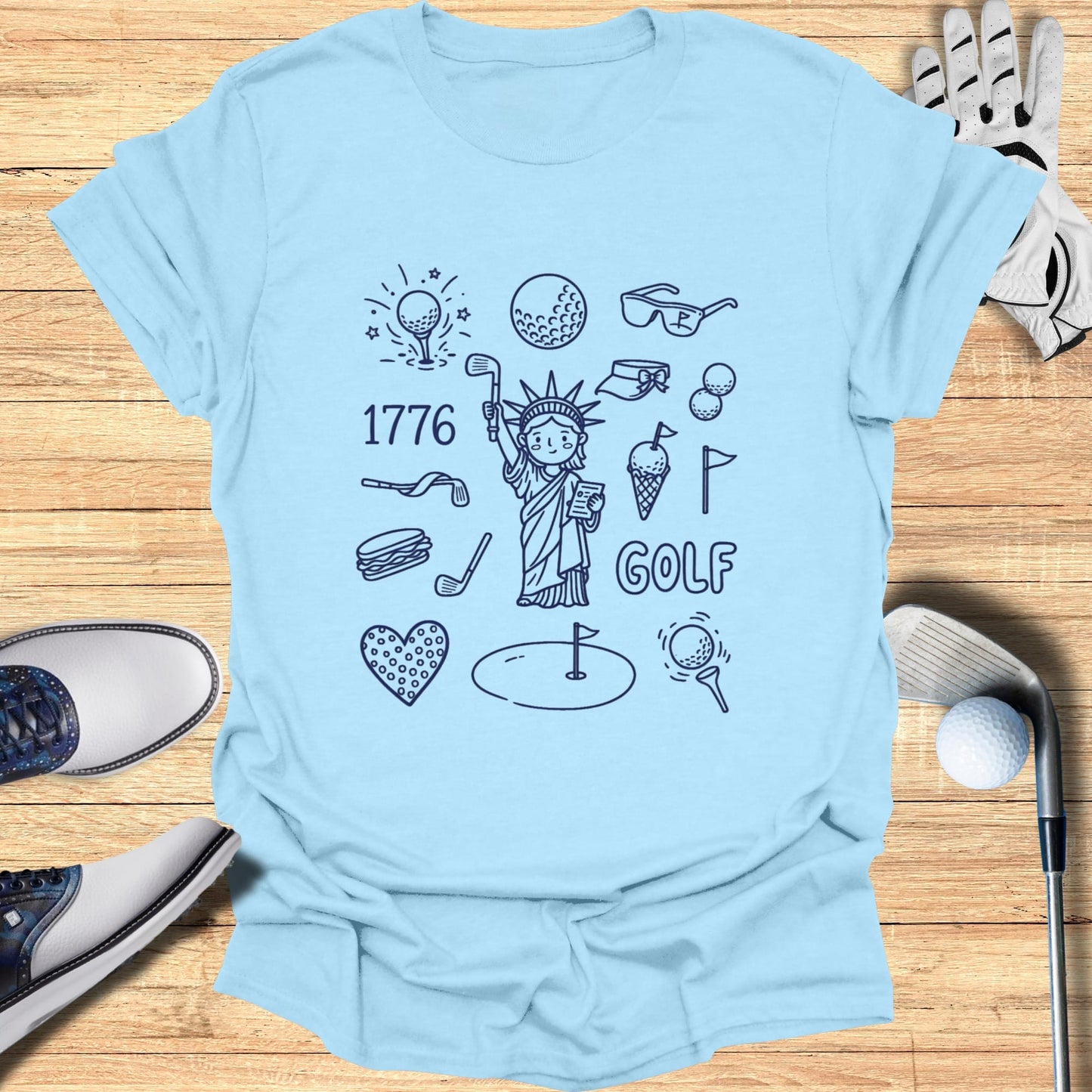 Light blue t-shirt with patriotic and golf-themed doodles.