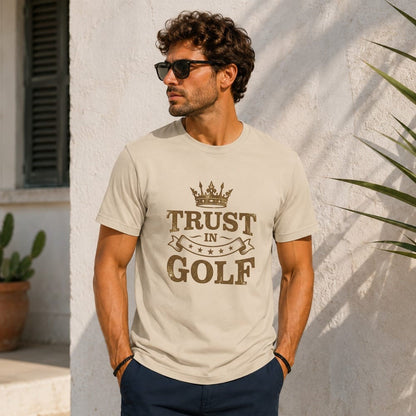 Man wearing a beige t-shirt with "Trust in Golf" text and crown design.