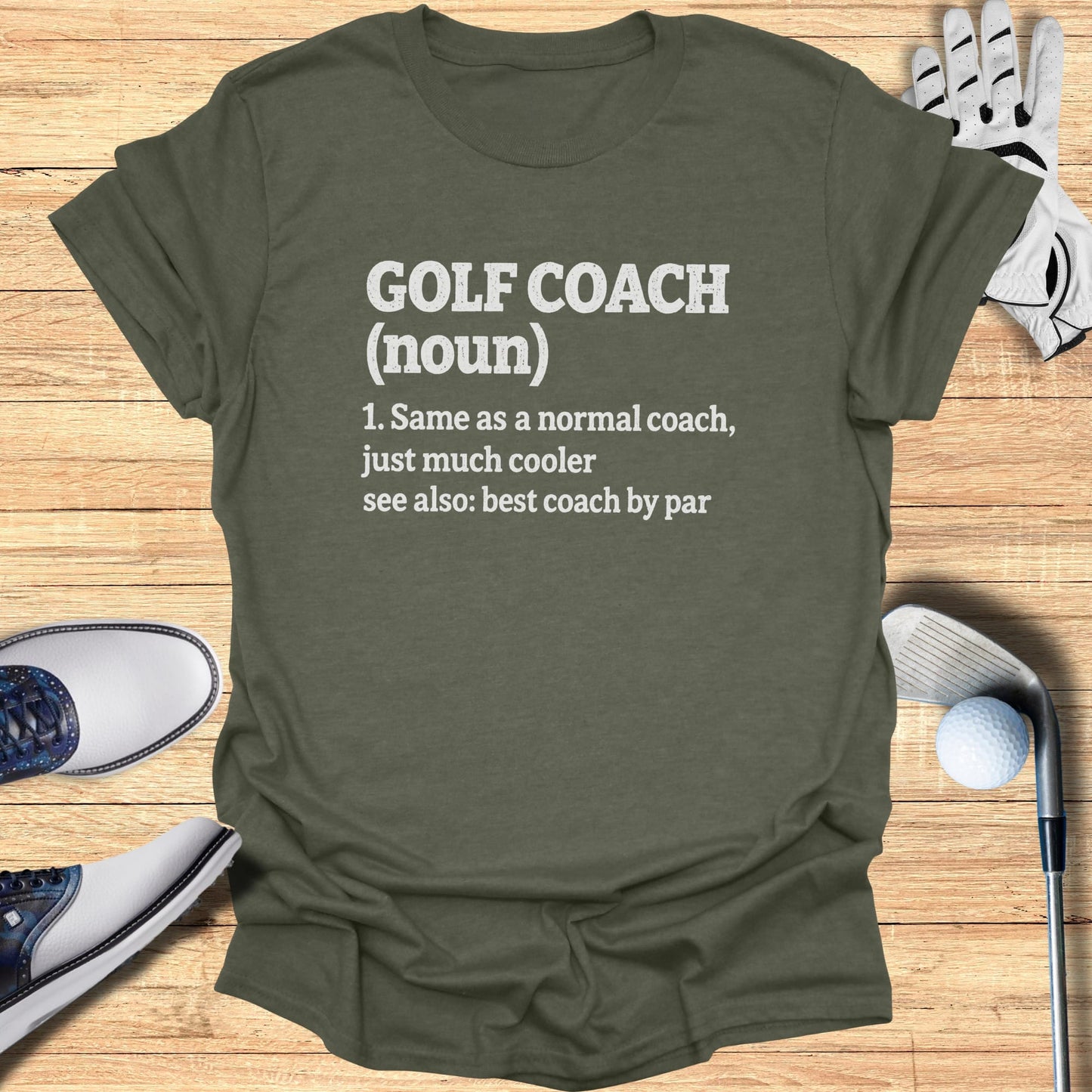 T-shirt with "GOLF COACH (noun)" definition and golf accessories.
